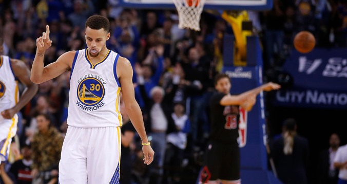 Golden State Warriors' Stephen Curry reacts after making a 3-point shot against the Chicago Bulls during the second half of an NBA basketball game Friday, Nov. 20, 2015, in Oakland, Calif. Warriors won 106-94. (AP Photo/Tony Avelar)